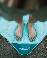 A person standing on our waterproof mats made for overlanding.